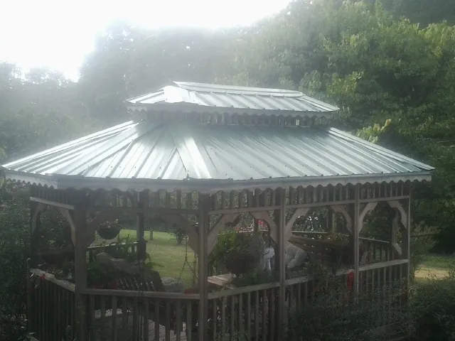 Two tier green metal roof on a garden gazebo in Sartell